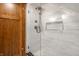 Elegant shower features seamless glass doors, stylish tilework, and sleek fixtures, creating a luxurious and modern bathroom space at 5677 Carrollton Ave, Indianapolis, IN 46220