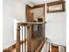 Stairwell landing featuring hardwood floors, iron railing and a stained wood window at 5677 Carrollton Ave, Indianapolis, IN 46220