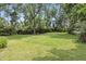 Large backyard with tall trees and luscious grass at 6125 Winthrop Ave, Indianapolis, IN 46220