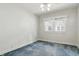 Bright bedroom featuring a ceiling fan, blue carpet, and double hung windows at 6125 Winthrop Ave, Indianapolis, IN 46220