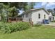 Exterior of the home featuring a small wood deck and well manicured lawn at 6125 Winthrop Ave, Indianapolis, IN 46220