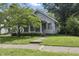 Charming home with a well-maintained front yard and mature trees at 6125 Winthrop Ave, Indianapolis, IN 46220