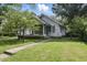 Charming home with a well-maintained lawn and cozy screened front porch perfect for enjoying the outdoors at 6125 Winthrop Ave, Indianapolis, IN 46220