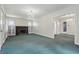 A cozy living room with a brick fireplace with built-in cabinets, an elegant chandelier and bright natural light at 6125 Winthrop Ave, Indianapolis, IN 46220