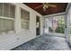 A sunroom with natural light from all the surrounding trees and easy access to the interior of the home at 6125 Winthrop Ave, Indianapolis, IN 46220