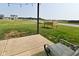 Backyard with grass, a cement patio, and an open view with houses in the distance at 680 Albermarle Dr, Pittsboro, IN 46167