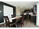 Charming dining room and kitchen featuring a modern black accent wall and stainless appliances at 680 Albermarle Dr, Pittsboro, IN 46167
