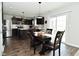 Bright eat-in kitchen features sleek appliances, dark cabinetry, and sliding glass doors at 680 Albermarle Dr, Pittsboro, IN 46167