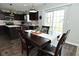Well-lit dining area showcases the dark wood floors and the sliding doors to the backyard at 680 Albermarle Dr, Pittsboro, IN 46167