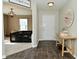 Charming entryway featuring hardwood floors, a decorative table, and a glimpse into the cozy living area at 680 Albermarle Dr, Pittsboro, IN 46167