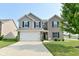 Two-story home with a well-manicured lawn, a two-car garage, and a combination of brick and siding at 680 Albermarle Dr, Pittsboro, IN 46167