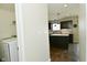 View from laundry room looking into stylish kitchen with dark cabinets and white countertops at 680 Albermarle Dr, Pittsboro, IN 46167