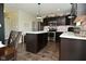 Modern kitchen with stainless appliances, dark cabinets, and a stylish center island at 680 Albermarle Dr, Pittsboro, IN 46167