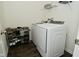 Well-organized laundry room featuring modern washer/dryer and convenient shoe rack at 680 Albermarle Dr, Pittsboro, IN 46167