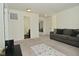 Open-concept living room with neutral walls, carpet, and comfortable gray sofa at 680 Albermarle Dr, Pittsboro, IN 46167