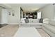 Open-concept living room with a view into the kitchen, featuring a comfortable sectional sofa at 680 Albermarle Dr, Pittsboro, IN 46167