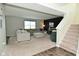 Spacious living room with a cozy sectional, a black accent wall and stairs to the second floor at 680 Albermarle Dr, Pittsboro, IN 46167