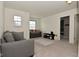 Spacious living room with neutral carpet and ample natural light at 680 Albermarle Dr, Pittsboro, IN 46167