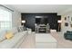 Living room with a sectional, fireplace and lots of cozy light at 680 Albermarle Dr, Pittsboro, IN 46167