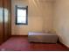 Bedroom features classic window, wardrobe, and comfortable bed set against pink carpet at 712 Cottage Ave, Anderson, IN 46012
