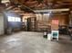Spacious garage interior with exposed beams and ample storage shelving at 712 Cottage Ave, Anderson, IN 46012