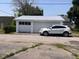 Two-car garage next to a white Cadillac SUV at 712 Cottage Ave, Anderson, IN 46012
