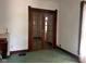 Living Room with wood trim, glass paneled double doors, and a fireplace at 712 Cottage Ave, Anderson, IN 46012