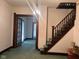 Living room with stairs and doorway to another room, complemented by an elegant chandelier at 712 Cottage Ave, Anderson, IN 46012