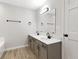 Bathroom with double sinks, modern vanity, wood grain floors and updated fixtures at 716 Royal Troon Ct, Avon, IN 46123