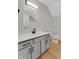 Updated bathroom with a gray vanity, black hardware, and wood-look floors at 716 Royal Troon Ct, Avon, IN 46123