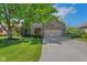 Charming brick home with a well-manicured lawn, mature tree, and attached two-car garage at 716 Royal Troon Ct, Avon, IN 46123