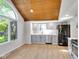 Bright kitchen featuring gray cabinets, stainless steel appliances, and wood-look floors at 716 Royal Troon Ct, Avon, IN 46123