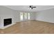 Bright living room featuring a fireplace, ceiling fan, and access to the outdoor space at 716 Royal Troon Ct, Avon, IN 46123