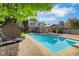 Backyard pool and deck with mature trees providing natural shade at 716 Royal Troon Ct, Avon, IN 46123