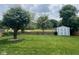 Lush backyard featuring mature trees, a wood fence, and a storage shed at 7175 Oakview Dr, Avon, IN 46123