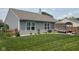 A serene backyard featuring a well-maintained lawn, flowerbeds, an outdoor living space, and tasteful landscaping at 7175 Oakview Dr, Avon, IN 46123