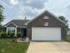 Charming single-story brick home with mature landscaping and a two-car attached garage at 7175 Oakview Dr, Avon, IN 46123