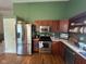 The kitchen features stainless appliances, wooden cabinets, laminate countertops and green accent wall at 7175 Oakview Dr, Avon, IN 46123