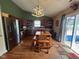 Bright eat-in kitchen with wood-look floors, stainless appliances, modern light fixture, and access to the patio at 7175 Oakview Dr, Avon, IN 46123