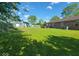 Spacious backyard featuring lush green grass, a fire pit, and a view of the house at 724 Iroquois St, Anderson, IN 46012