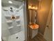 This bathroom features a shower stall and a modern vanity with a sink and updated lighting at 724 Iroquois St, Anderson, IN 46012