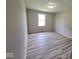 Bedroom showing a window for natural light and neutral wall paint at 724 Iroquois St, Anderson, IN 46012