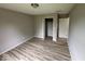 Bedroom with a closet and doorway to another room, plus modern floors and neutral paint at 724 Iroquois St, Anderson, IN 46012