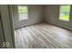 Bedroom with dual windows and modern floors has great natural light and is freshly painted at 724 Iroquois St, Anderson, IN 46012