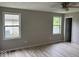Spacious bedroom with windows, modern floors, and neutral paint leads to the hallway at 724 Iroquois St, Anderson, IN 46012