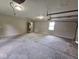 Spacious garage featuring ample room for parking and storage with a gray concrete floor and overhead lighting at 724 Iroquois St, Anderson, IN 46012