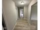 Hallway with wood flooring, neutral gray paint, white trim, and a closet at 724 Iroquois St, Anderson, IN 46012