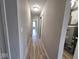 Hallway with durable floors, access to a utility closet, and multiple bedrooms at 724 Iroquois St, Anderson, IN 46012