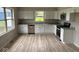 Modern kitchen with white cabinets, stainless steel appliances, and granite countertops at 724 Iroquois St, Anderson, IN 46012