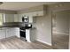 Bright kitchen features white cabinets, stainless appliances, and granite countertops at 724 Iroquois St, Anderson, IN 46012